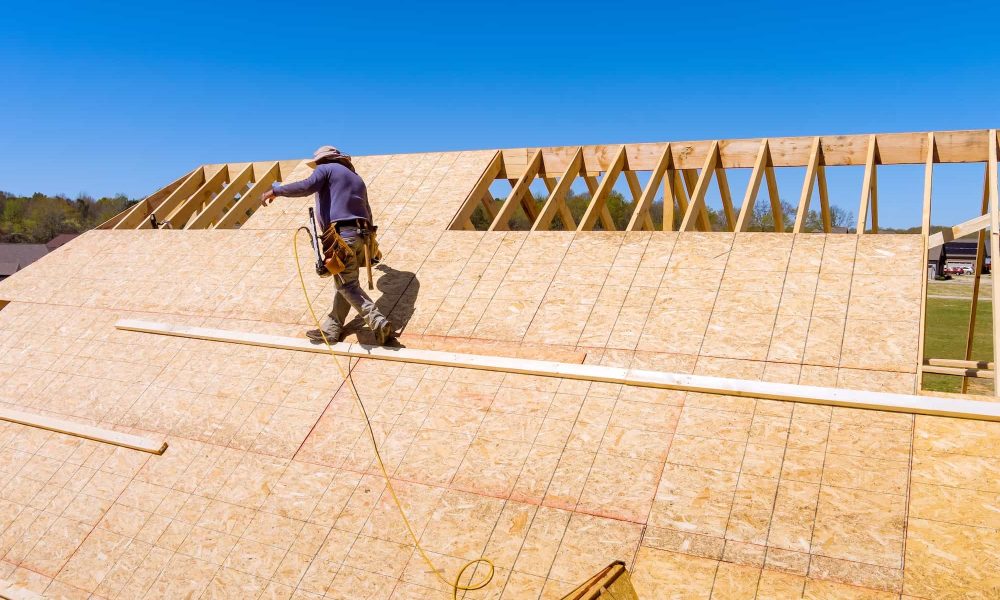 Home roof construction applying roof plywood panels in new house