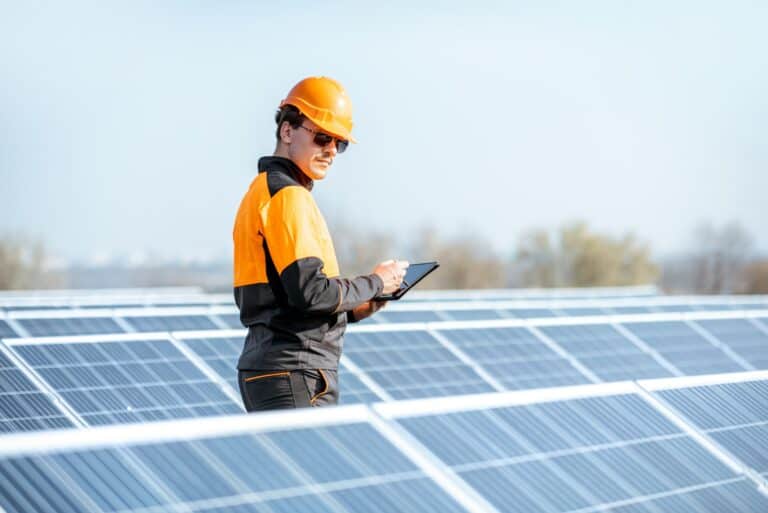 Engineer servicing solar panel on electric plant