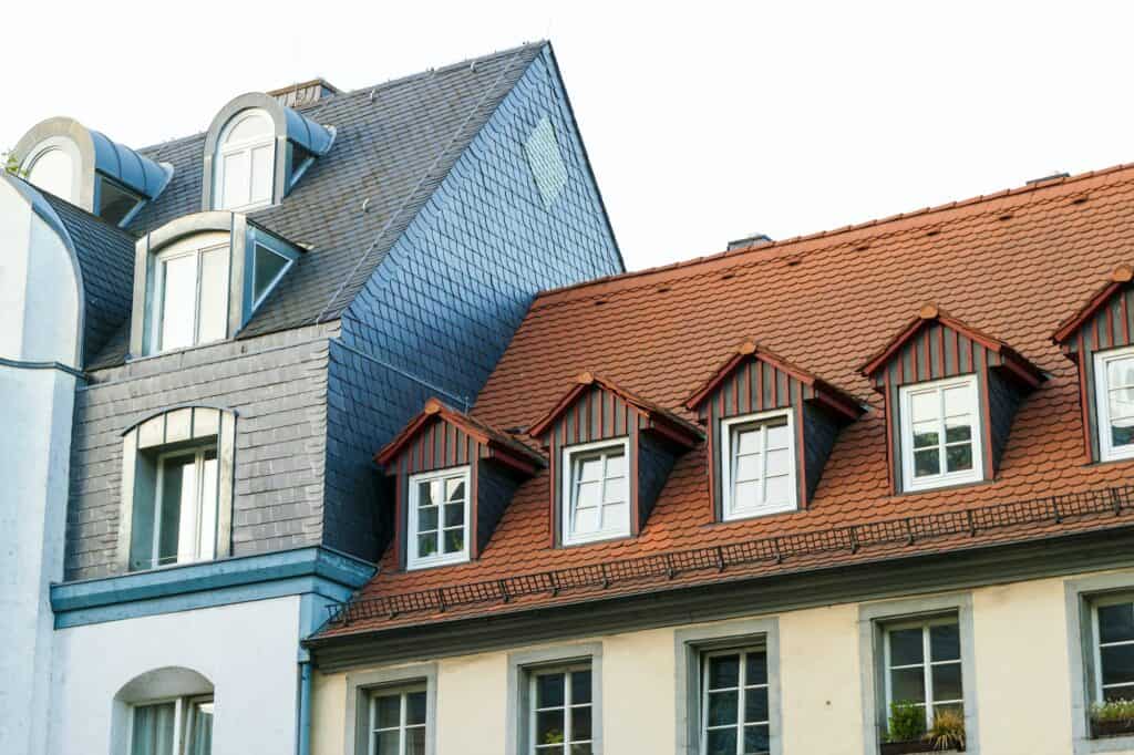 Roofs of old houses with roof windows and orange roof tiles in German city